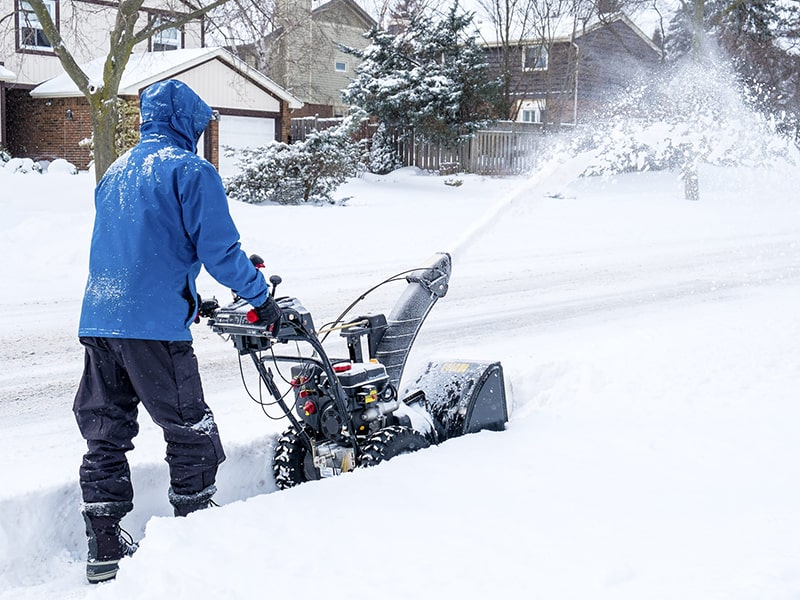 This image shows a person plowing snow. LandTech Landscaping specializes in snow removal and snow plowing in NH. 